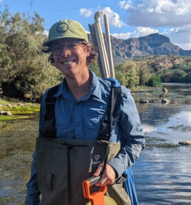 Luke Ramsey-Wiegmann standing in Salt River with field gear.